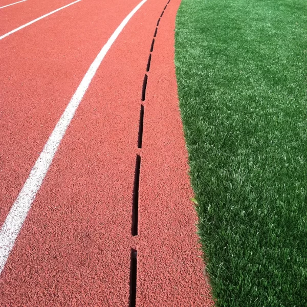 ACO Sport Precast Slot Drainage System installed along the side of a running track