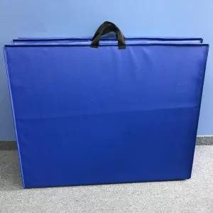 blue aerobic mats with handles folded up and leaning against the wall