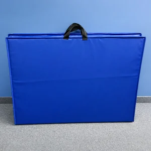 blue aerobic mats with handles set up against the side of a storage room