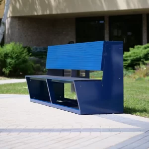 An blue aluminum team bench by Sportsfield Specialties sitting on the side of the court yard