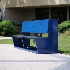 An blue aluminum team bench with replaceable black mat by Sportsfield Specialties sitting on the side of the court yard