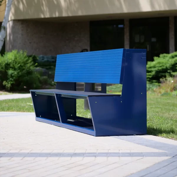 An blue aluminum team bench by Sportsfield Specialties sitting on the side of the court yard