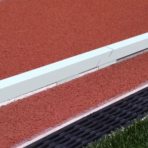 White powder coated aluminum track curbing showing a clear boundary around the track