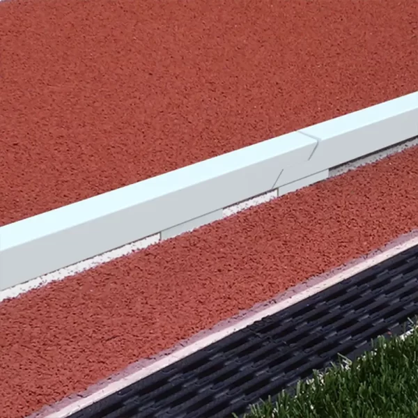 White powder coated aluminum track curbing showing a clear boundary around the track