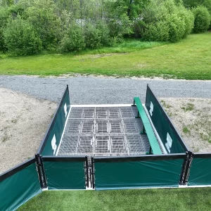 a barrier containment system installed on the edge of a synthetic turf playing field with vinyl coated mesh along the chain link fence