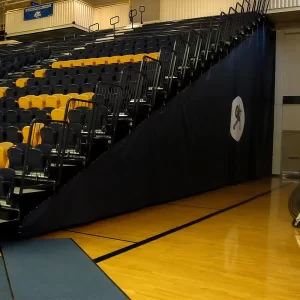 mesh bleacher enclosures by sportsfield specialties installed on bleachers in a gymnasium