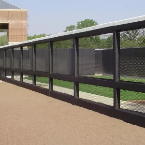 black post and gray rail padding installed at a baseball field