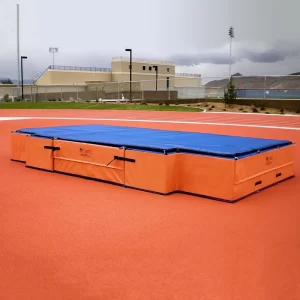 Orange and blue DuraZone® High Jump Landing Pads installed on an undisclosed track & field