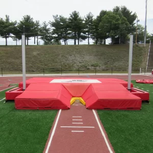 DuraZone® Pole Vault Landing Pad resting on turf inside the track with custom digitally printed graphics
