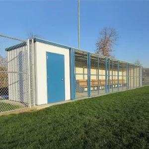 An enclosed dugout by sportsfield specialties installed with a storage closet and polyboard team benches
