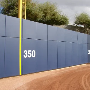 blue BaseZone® field wall padding installed in the outfield of a baseball or softball playing field