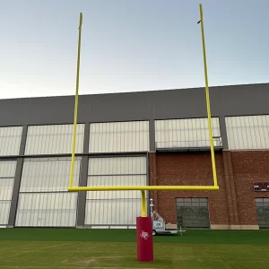 a football goal post installed on a synthetic field with football goal post pads. The pad has digitally printed graphics.