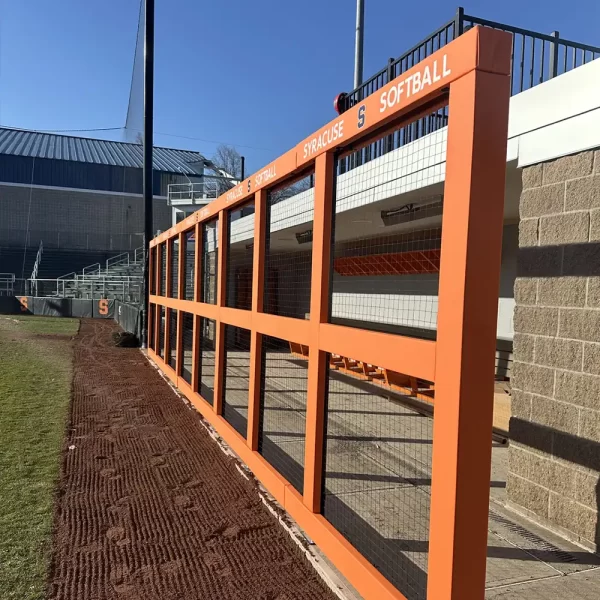 dugout guard rail systems with orange covered vinyl installed at the Syracuse softball playing field - with digitally printed graphics