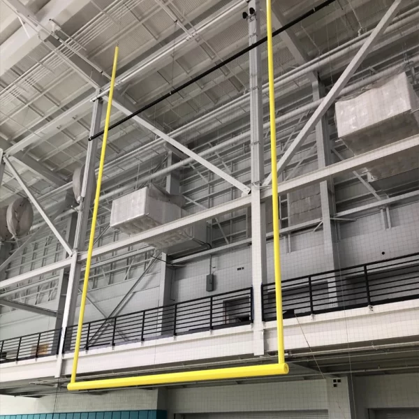 hanging retractable netting system hung from the ceiling of an indoor football practice facility