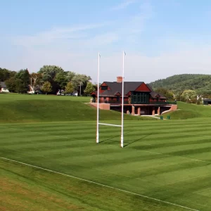 a hinged rugby goal post installed on a playing field