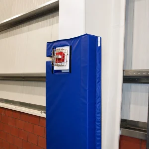 an ibeam inside a gymnasium is wrapped in blue indoor i-beam padding to protect fans and players alike