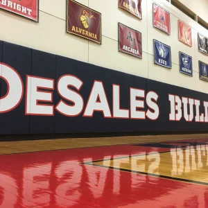 black indoor wall padding installed at DeSales with digitally printed graphics