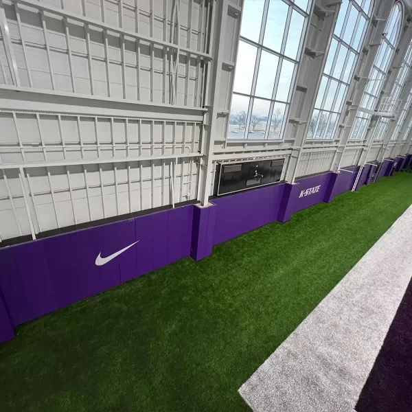 looking at purple indoor wall padding installed inside k-state practice facility