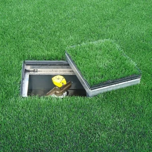 a turfcool® irrigation box open and installed in a synthetic turf field with the cover sitting off to the side
