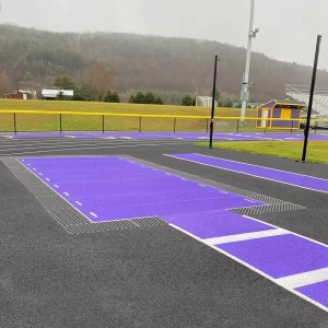 A finished JumpForm® Sand Pit Forming System with purple sand pit covers