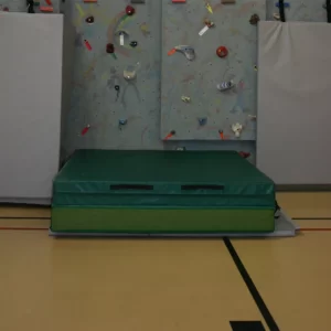 Landing zone mat by Sportsfield Specialties laid out below climbing wall