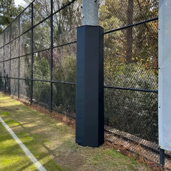 black light post padding installed on light pole in front of a chain link fence