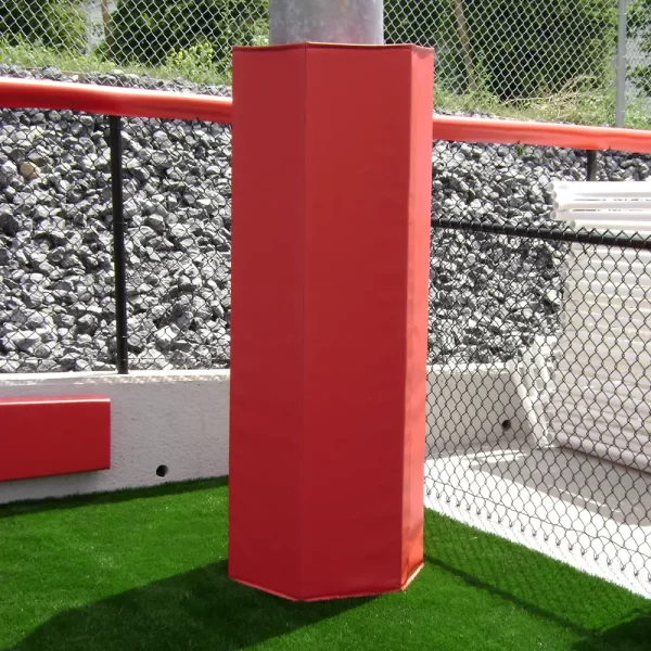 red hexagonal light post padding installed to the side of a synthetic turf field