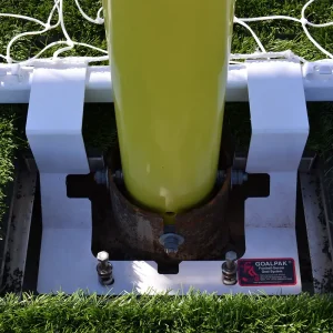 a goalpak® lockdown safety system installed on a synthetic turf playing field in the locked position preventing the soccer goal from tipping during game play
