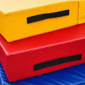 a set of yellow, red, and blue multi-purpose training mats stacked on a gym surface