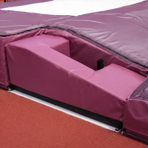 a pole vault base protector pad sitting on the base of a pole vault standard