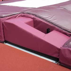 Maroon Pole Vault Base Protector Pads installed with matching pole vault landing pads by sportsfield specialties