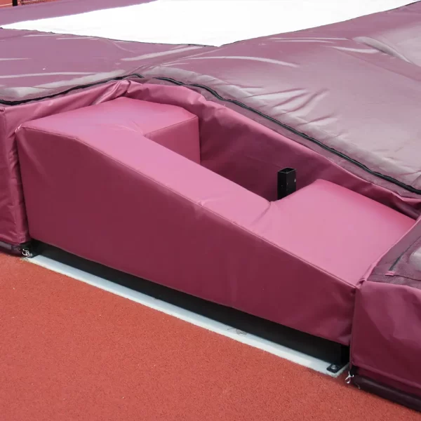 Maroon Pole Vault Base Protector Pads installed with matching pole vault landing pads by sportsfield specialties