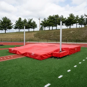 a sportsfield specialties DuraZone® pole vault landing system sitting in the pole vault area of a high school track & field facility