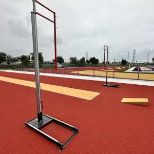 Pole vault standards sitting on the track surface waiting for the pole vault padding to be installed
