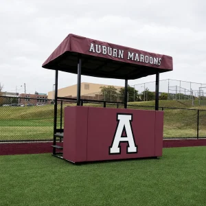 an elevated scorers table sitting on the sidelines of Auburn Maroons field