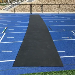 a roll-out track protector is laid across a blue running track