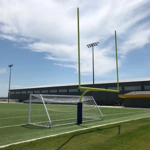 a rotating football goal post installed behind a soccer goal in the rotated position