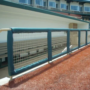 green round guard rail padding installed on the railings of below ground enclosed dugout
