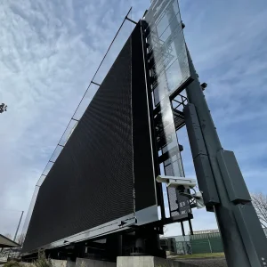 a large digital scoreboard protected by scoreboard netting systems