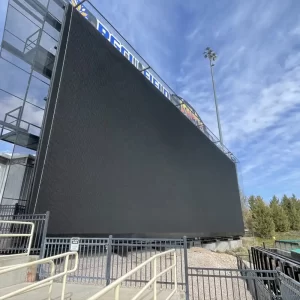 Custom scoreboard netting system installed by sportsfield specialties protecting a digital scoreboard
