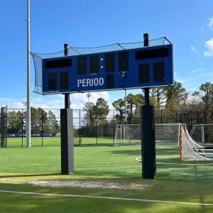 black hexagonal scoreboard i-beam padding installed on posts holding a scoreboard