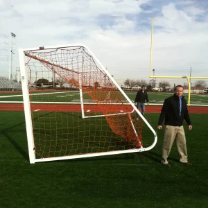 a regulation soccer goal being moved by two Sportsfield Specialties sales reps using the integrated soccer goal wheel kit