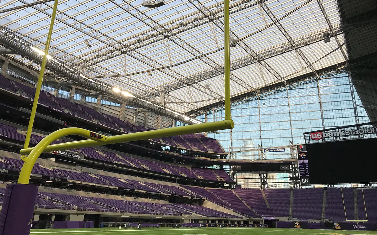looking down the field through a football goal post of us bank stadium