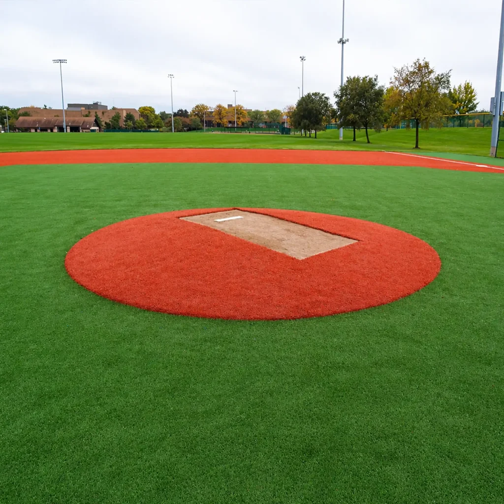 a seasonal pitching mound sitting on a synthetic turf baseball playing field