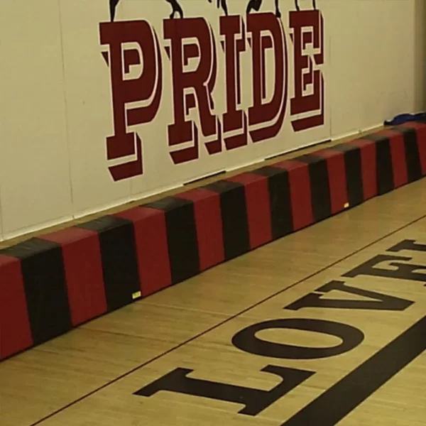 red and black stage mats installed in gymnasium