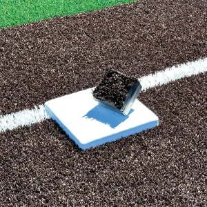 a base installed into a synthetic turf access frame kit, with the plug resting on the base