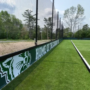 a synthetic turf infill barrier containment system installed along the side of the Cardigan Mountain School playing field