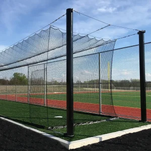 a tension batting tunnel installed in the practice area of a college baseball field