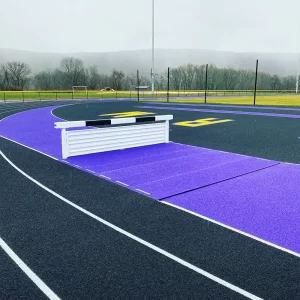 Adjustable Steeplechase Water Jump Pit Hurdle installed on the track ready for the steeplechase event