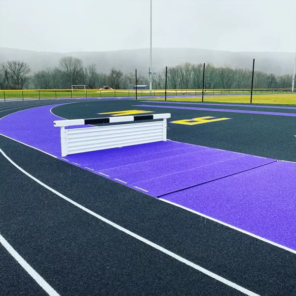 Adjustable Steeplechase Water Jump Pit Hurdle installed on the track ready for the steeplechase event